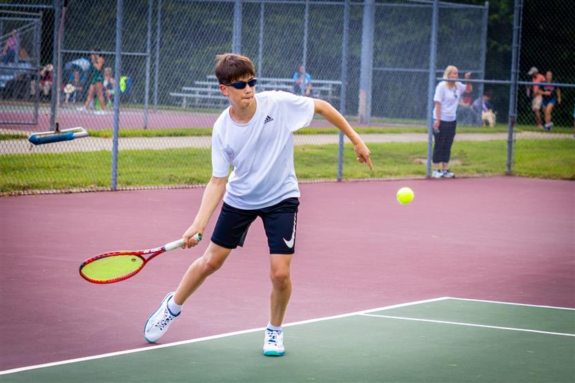 A tennis player hits the ball